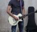 A suede guitar strap on an instrument