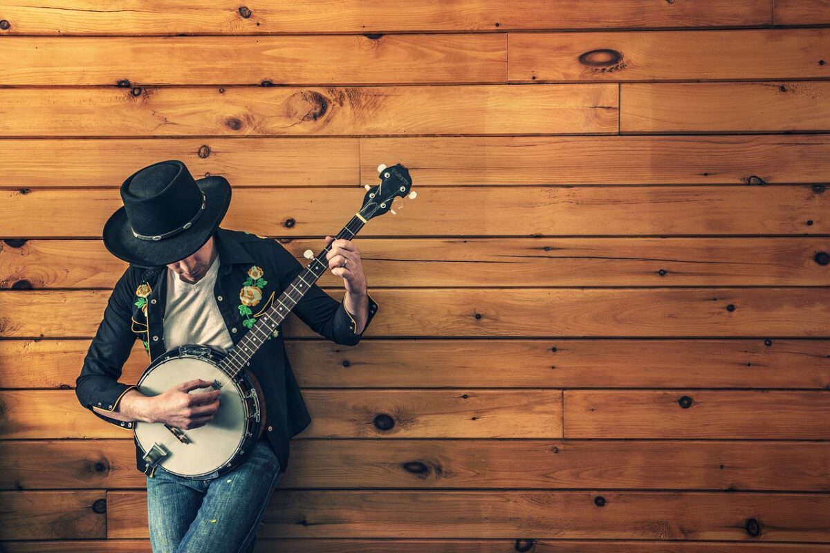 A guitar hanging from a wall mount